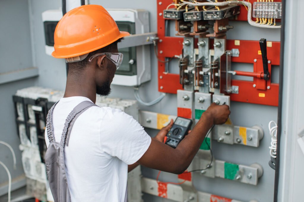 electrician checking voltage in switchgear